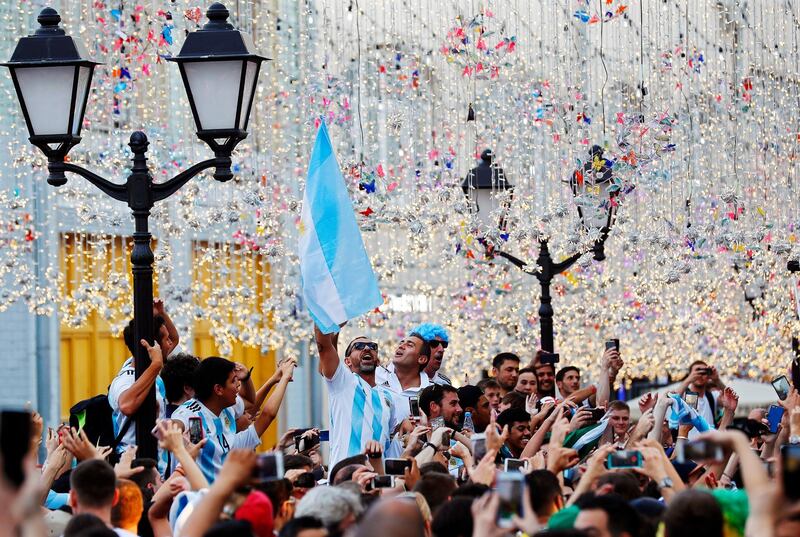 epa06819716 Supporters of Argentina cheer for their team on the Nikolskaya Street in central Moscow, Russia, 18 June 2018. The FIFA World Cup 2018 takes place in Russia from 14 June until 15 July 2018.  EPA/FELIPE TRUEBA