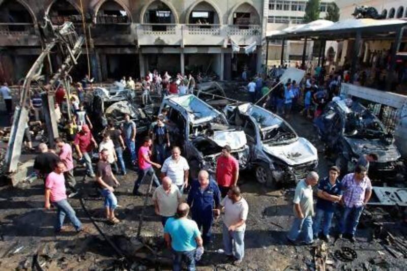 People gather outside the Al Taqwa mosque in the northern city of Tripoli after it was hit by twin car bombs.