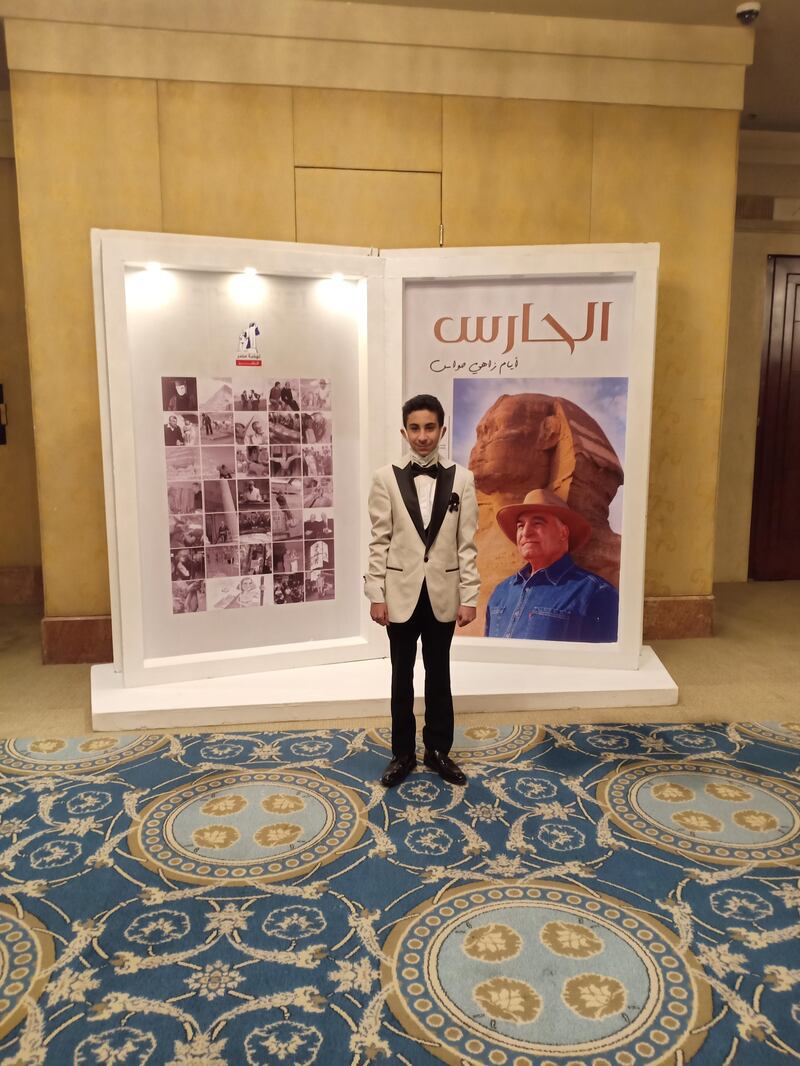 Youssef stands in front of a promotional display for 'The Guardian'. Zahi Hawass, who also served as Egypt's antiquities minister, signed a copy for the young Egyptologist. Photo: Sami Hawas