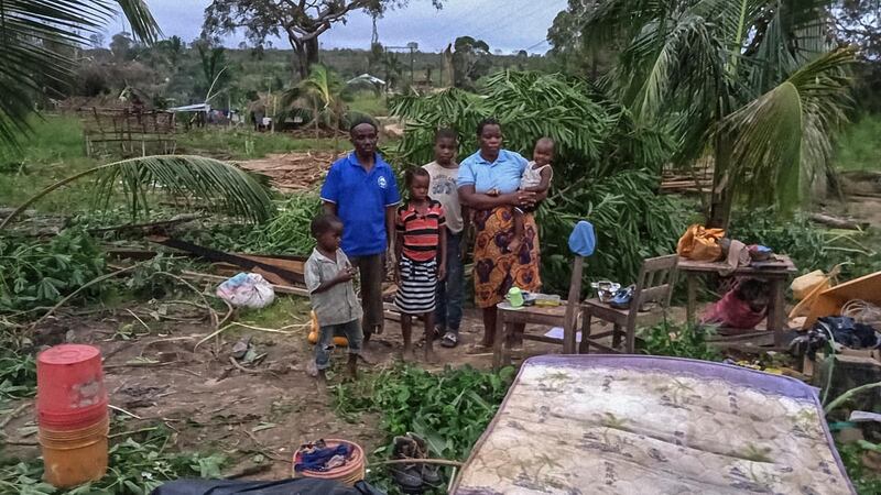 Parents Maria Mendosa and Assan Madal stand with their children Pizere, Naturesa, Ancha, Ida and Luigi beside their totally destroyed home in the village of Nacate, south of Macomia. after the cyclone Kenneth hit the area. Heavy rains from a powerful cyclone lashed northern Mozambique sparking fears of flooding as aid workers arrived to assess the damage.  AFP