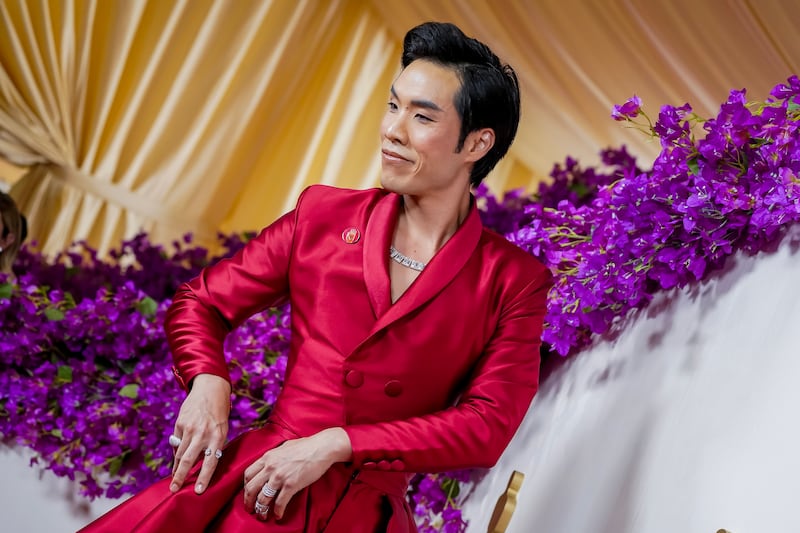 American filmmaker and actor Eugene Lee Yang wears the red pin. EPA