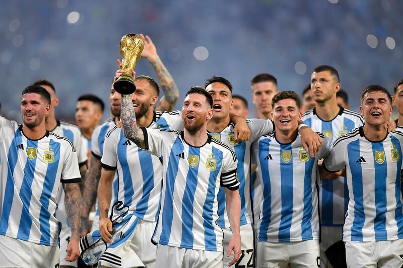 Lionel Messi and his teammates parade the World Cup trophy after an international friendly match against Curacao. Getty