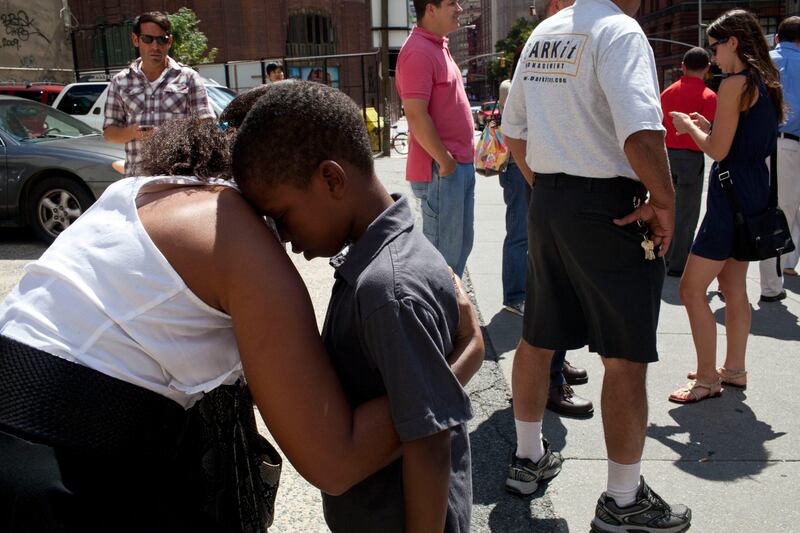 NEW YORK, NY - AUGUST 23: Suzanne Beatty comforts her son Quentin Beatty, 7, on a street in TriBeCa after a 5.9 earthquake struck on August 23, 2011 in New York, United States. The epicenter of the 5.9 earthquake was located near Louisa in central Virginia. Two nuclear power plants at the North Anna Power Station in the same county were reportedly taken offline.   Andrew Burton/Getty Images/AFP== FOR NEWSPAPERS, INTERNET, TELCOS & TELEVISION USE ONLY ==
 *** Local Caption ***  666334-01-09.jpg