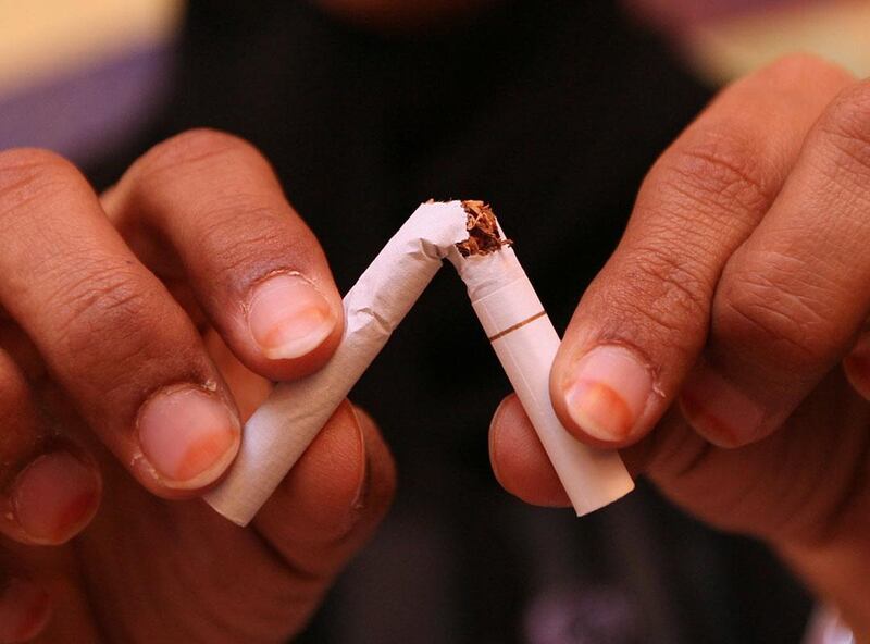 DUBAI-MAY 14,2008 - Wedad al Maidoor , Head of the Tobacco Control Advisory Group breaks a cigarette that symbolize the anti-smoking law during interview at Al Ittihad Medical Clinic in Dubai. ( Paulo Vecina/The National ) *** Local Caption ***  PV smoking 3.JPGPV smoking 3.JPGAL25May_Crown_NoSMoking.jpg