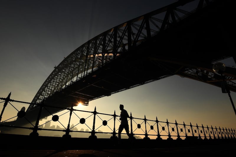 A jogger runs along Sydney Harbour as thick smoke blankets the greater Sydney Basin in Sydney.