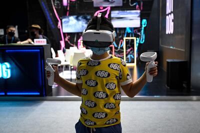 A child plays a virtual reality game during the World Metaverse Conference in Beijing. AFP