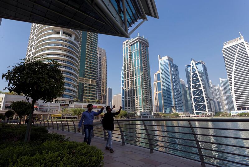 Dubai, United Arab Emirates - October 18th, 2017: Standalone. People at Jumeirah Lake Towers point at some of the skyscrapers. Wednesday, October 18th, 2017 at JLT, Dubai. Chris Whiteoak / The National