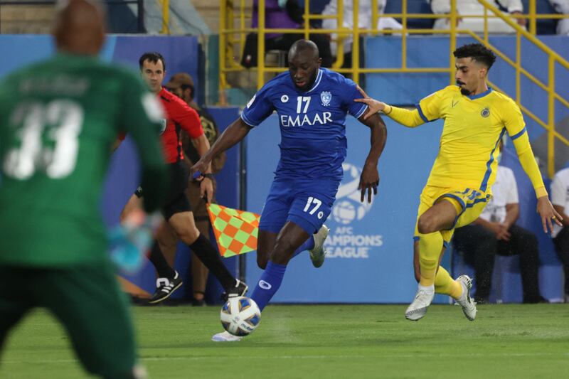 Al Hilal's forward Moussa Marega is marked by Al Nassr's defender Ali Lajami. AFP