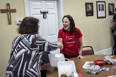 Jane Timken, a Republican candidate for the US Senate in Ohio, greets people at a barbecue lunch in the state on Monday. AFP
