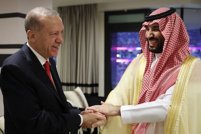Turkish President Recep Tayyip Erdogan shakes hands with Saudi Arabia's Crown Prince Mohammed bin Salman at the opening ceremony of the World Cup in Qatar. AFP