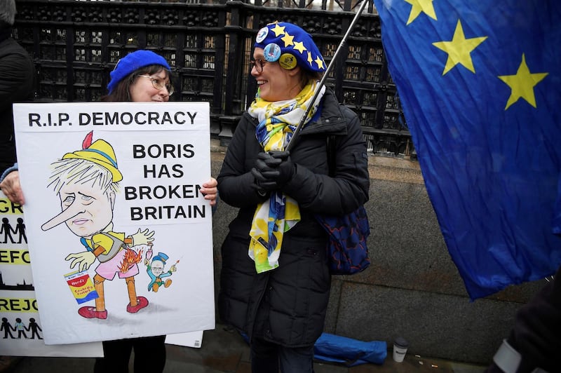 Anti-Brexit protesters holding a banner and an EU flag demonstrate outside the Houses of Parliament in London, Britain. Reuters