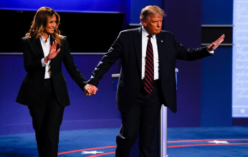 President Donald Trump and first lady Melania Trump wave as they leave the stage. Reuters