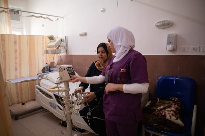 Nurse Jawaher Salah, right, with patient Fatma Ali.
