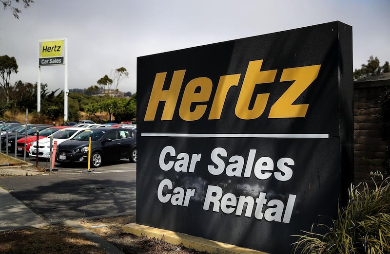 (FILES) In this file photo a sign is posted in front of a Hertz car sales and rental office on August 8, 2017 in South San Francisco, California.  After laying off 10,000 employees in North America in the wake of the coronavirus's massive hit to tourism, the company the car-rental giant Hertz has filed for bankruptcy on May 22. / AFP / GETTY IMAGES NORTH AMERICA / JUSTIN SULLIVAN
