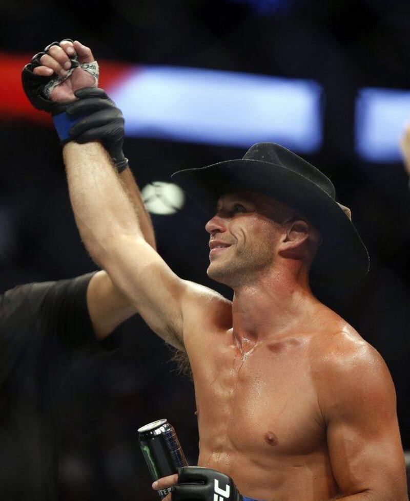 Donald Cerrone raises his hand after defeating Rick Story in their welterweight bout at UFC 202. AP