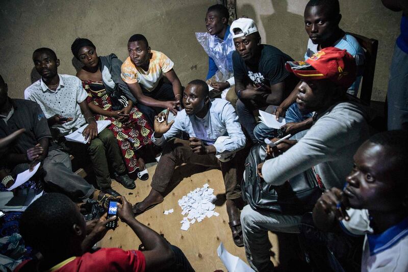 TOPSHOT - Improvised electoral agents count ballots after a symbolic vote on December 30, 2018, at Kalinda Stadium in Beni, where voting was postponed for Democratic Republic of Congo's general elections. After two years of delays, crackdowns and political turmoil, the Democratic Republic of Congo voted on December 30 in presidential elections that will determine the future of Africa's notoriously unstable giant. Electoral authorities have postponed the vote until March 2019 in several troubled areas such as Beni and Butembo in North Kivu province (eastern RDCongo), and in Yumbi (western RDCongo). / AFP / ALEXIS HUGUET
