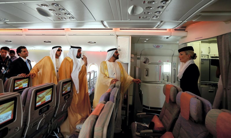 Ruler of Dubai Sheikh Mohammed Bin Rashid al-Maktoum (C), takes a tour of the Emirates A380 airliner, during the opening ceremony of the Dubai Airshow on November 17, 2013. AFP PHOTO/MARWAN NAAMANI (Photo by MARWAN NAAMANI / AFP)