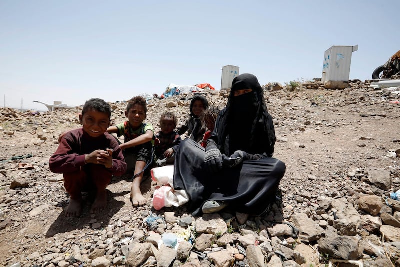 epa09195058 A displaced Yemeni woman and children sit at a camp for Internally Displaced Persons (IDPs) on the outskirts of Sana'a, Yemen, 10 May 2021 (Issued 12 May 2021). The UN Security Council held 12 May 2021 consultations on the latest developments in Yemen in which the UN envoy to Yemen, Martin Griffiths, complained that his efforts to end the country's six-year war were not gaining traction, accusing the Houthis of continuing a military escalation despite his efforts to cut a ceasefire deal with Yemen's Saudi-backed government. The prolonged conflict has plunged Yemen into the world's largest humanitarian crisis with an estimated 80 percent of Yemen's 29 million-population are in need of humanitarian assistance, and led to the displacement of more than three million people.  EPA/YAHYA ARHAB