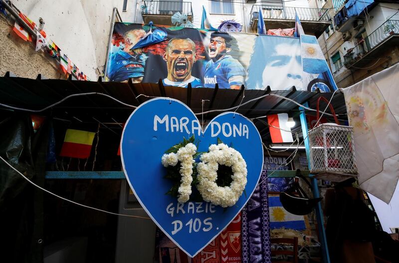A heart-shaped placard reading "Maradona, thanks God" is pictured the day after the death of Diego Maradona, in Naples. Reuters