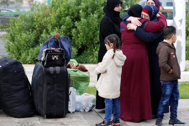 A girl stands near luggage of Syrian refugees returning home from Beirut, Lebanon. Reuters