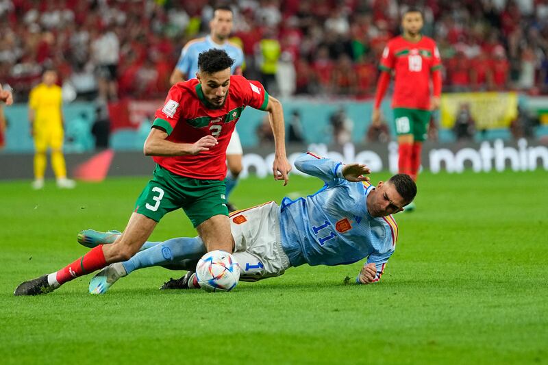 Morocco's Noussair Mazraoui and Spain's Ferran Torres battle. AP 