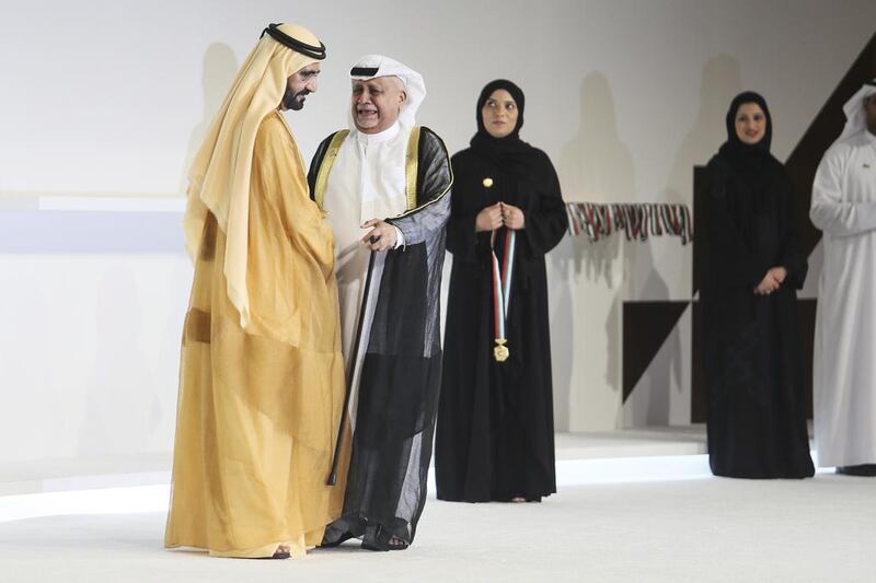 Sheikh Mohammed bin Rashid, Vice President and Ruler of Dubai, presents a medal to Ahmed Mohammed Al Mansoori. Sarah Dea / The National