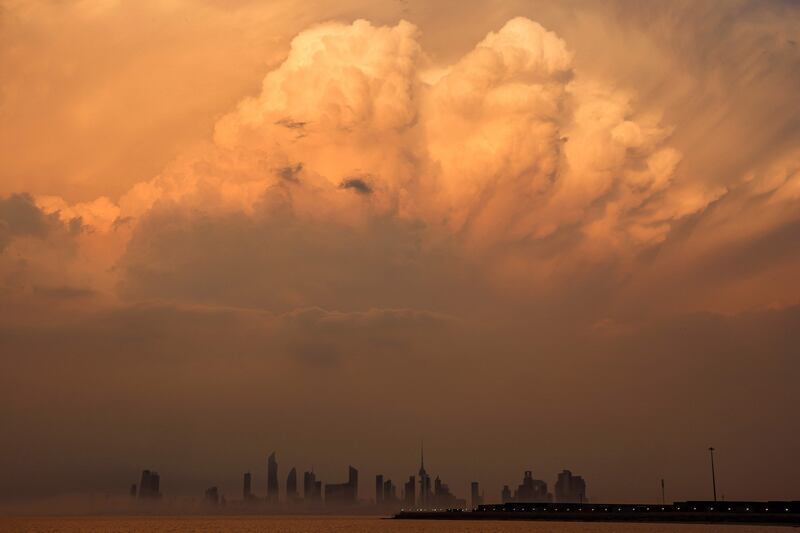 Clouds on the skyline of Kuwait City at sunset. AFP

