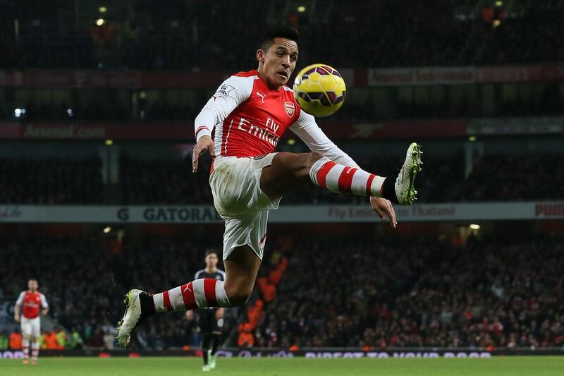 Arsenal’s Alexis Sanchez leaps to control the ball during the English Premier League match against Newcastle United at the Emirates Stadium in London on December 13, 2014. Tim Ireland / AP Photo