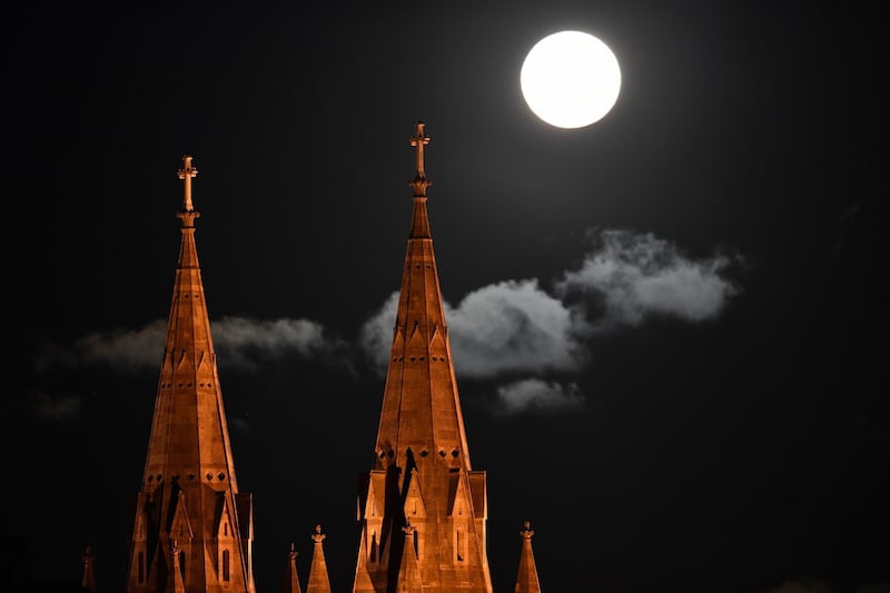 Shining brightly, the supermoon rises over Saint Peter's Cathedral in Adelaide, Australia. EPA