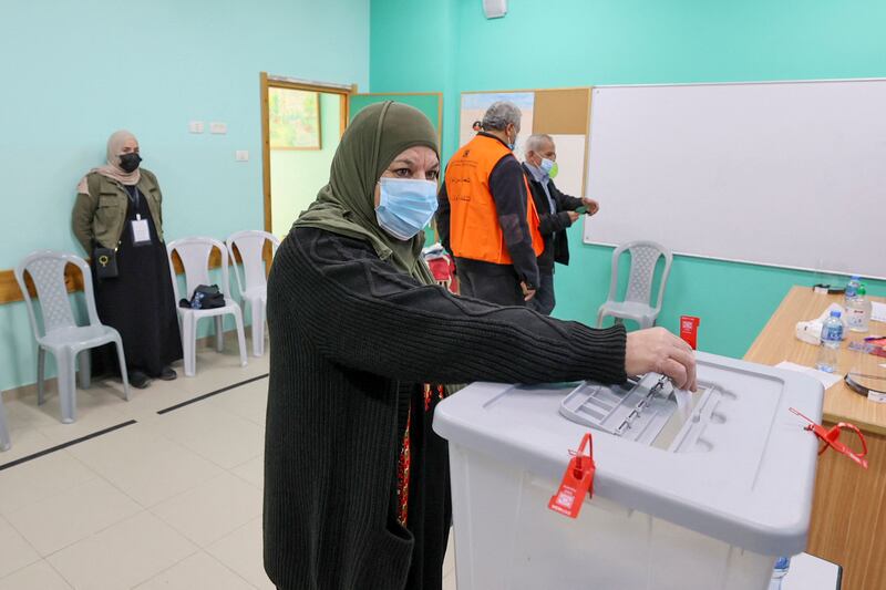 A woman casts her vote during municipal elections, in the village of Baitain, east of the occupied West Bank city of Ramallah. The previous municipal vote took place in 2017. AFP