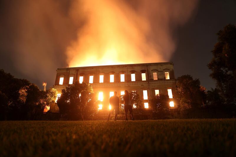 People watch as a fire burns at the National Museum of Brazil in Rio de Janeiro. Reuters