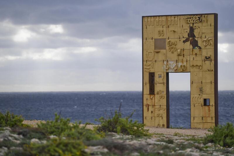 epa07905060 A view of the 'Door of Europe' (Porta d'Europa) by Italian artist Mimmo Paladino, a monument dedicated to migrants and located on a promontory in Lampedusa island, Sicily, southern Italy, 08 October 2019. The Italian Coast Guard and Italian finance police on 07 October 2019 rescued 22 survivors and recovered the bodies of 13 people, all women from Western Africa, after a boat carrying about 50 migrants overturned Sunday night a few miles off the coast of Lampedusa. According to an initial reconstruction of event, when rescue patrol boats arrived to rescue the migrants from the boat, all the migrants moved to one end of the boat, causing it to overturn. Survivors said eight children are among those missing.  EPA/CIRO FUSCO