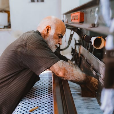 It takes more than a year to master one of the hulking looms in the Hirbawi factory. Sarah Maisey / The National