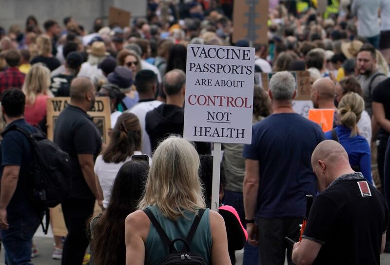 Demonstrators hold up banners as they listen to speeches during a "Rally for freedom" protest in London.