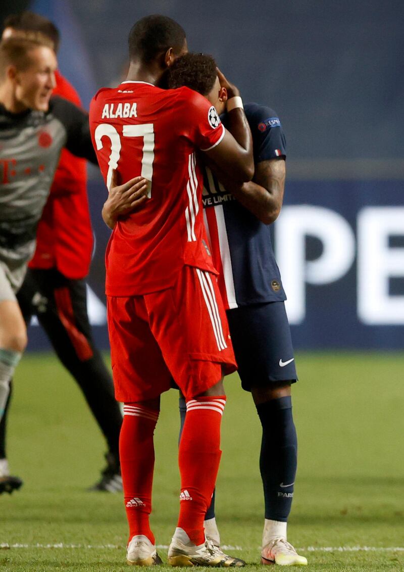 Bayern's David Alaba, left, comforts PSG's Neymar. Pool via AP