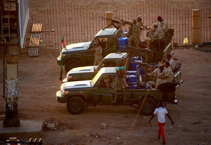 Members of Sudan's intelligence services shoot bullets in the air at the headquarters of the Directorate of General Intelligence Service. AFP