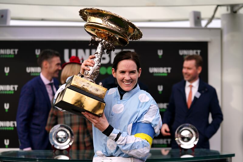 Jockey Rachael Blackmore holds the trophy after winning the Unibet Champion Hurdle Challenge Trophy on Honeysuckle. PA
