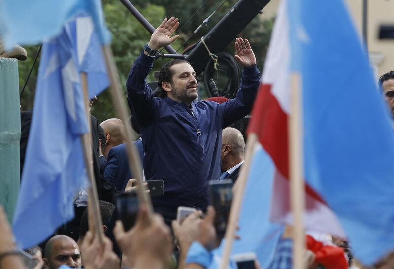 TOPSHOT - Lebanese prime minister Saad Hariri greets his supporters upon his arrival at his home in Beirut on November 22, 2017.
Hariri, back in Beirut after a mysterious odyssey that saw him announce his resignation in Saudi Arabia, told cheering supporters that he was staying. / AFP PHOTO / MARWAN TAHTAH