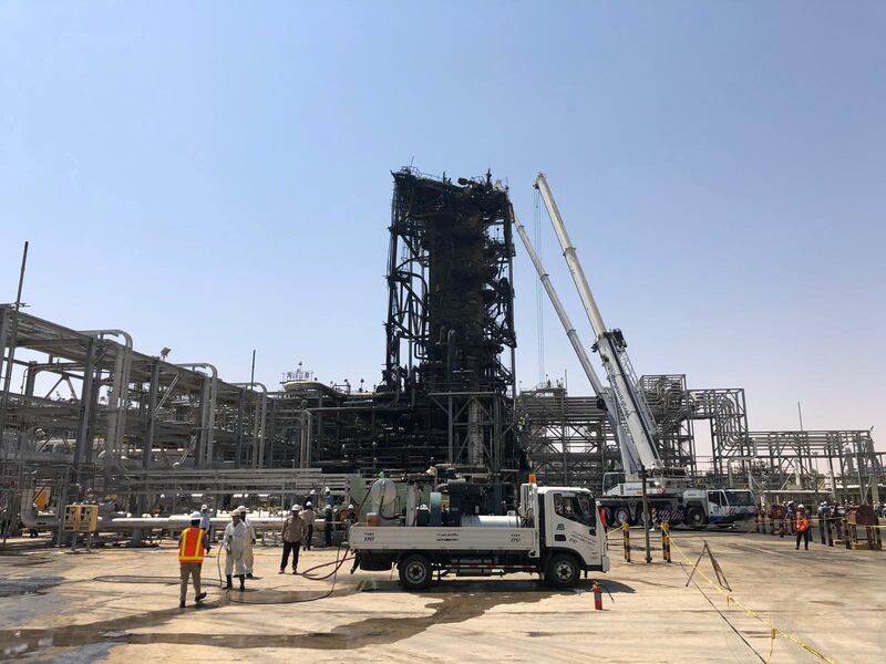 Workers are seen at the damaged site of Saudi Aramco oil facility in Khurais. Reuters