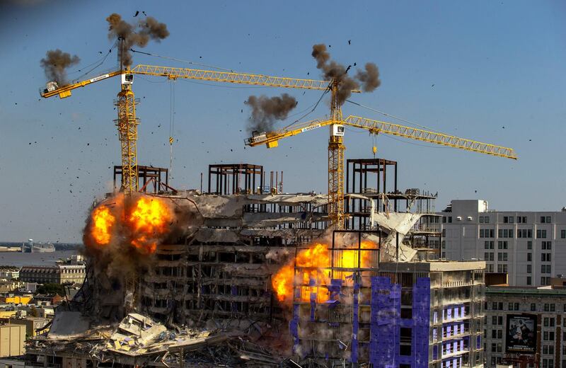 Two large cranes on the Hard Rock Hotel construction come crashing down in a controlled explosion in New Orleans.  AP