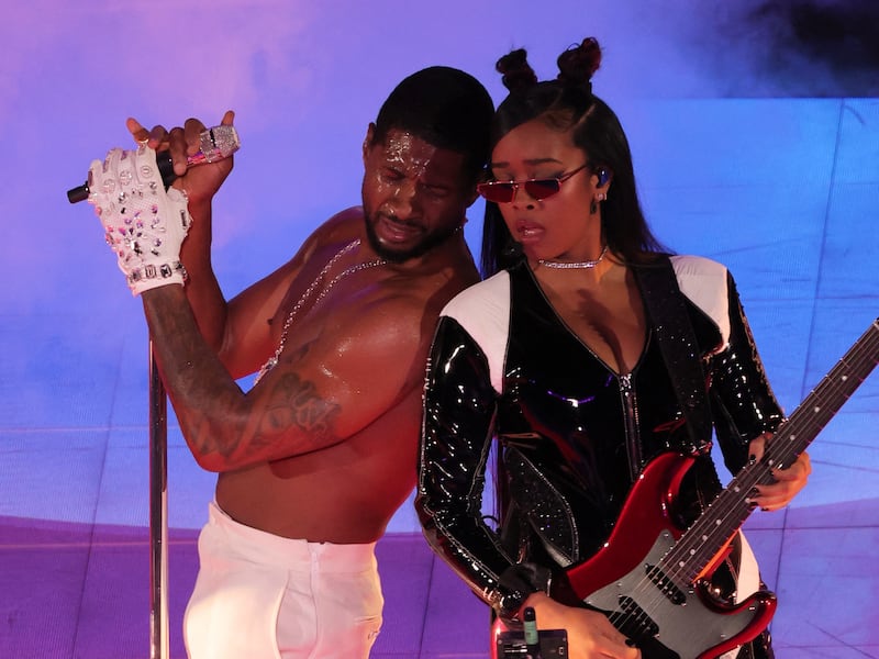 Usher is joined by singer Her during the half-time show. Reuters