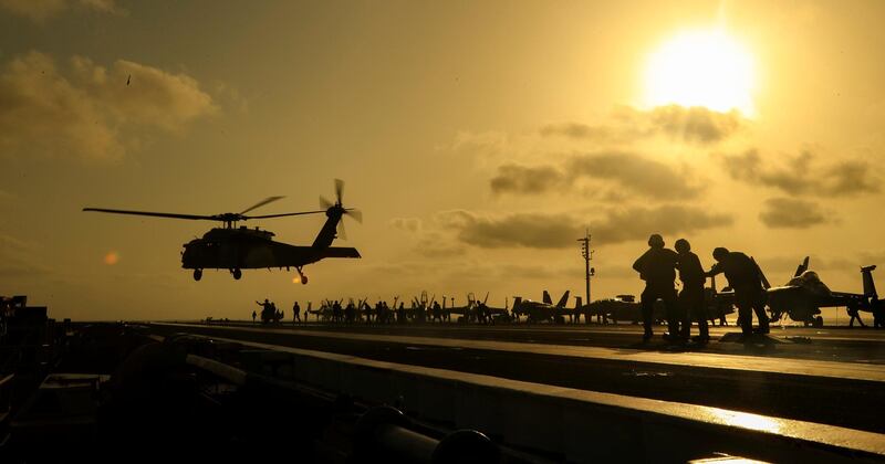 An MH-60S Sea Hawk helicopter lifts off the flight deck of the US Navy aircraft carrier USS Abraham Lincoln, in Arabian Sea.  Reuters