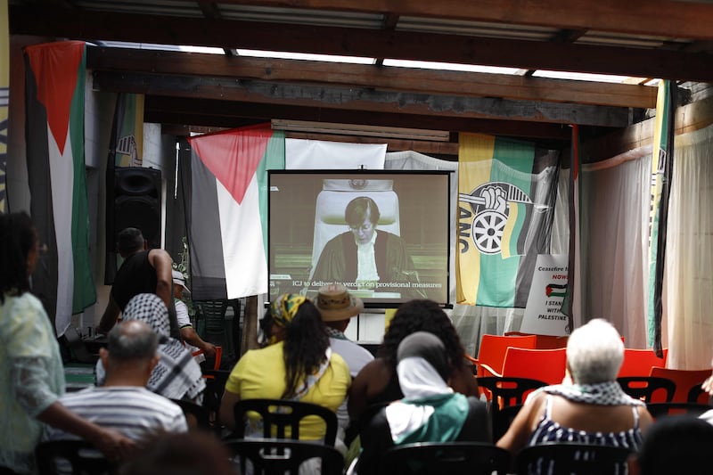 Residents gather at the Dullah Omar Centre in Cape Town to watch the ruling in The Hague. AFP