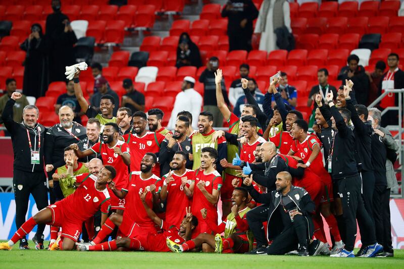 Oman's players celebrate their win in the Fifa Arab Cup 2021 Group B match against Bahrain at the Ahmed bin Ali Stadium in the Qatari city of Ar Rayyan.