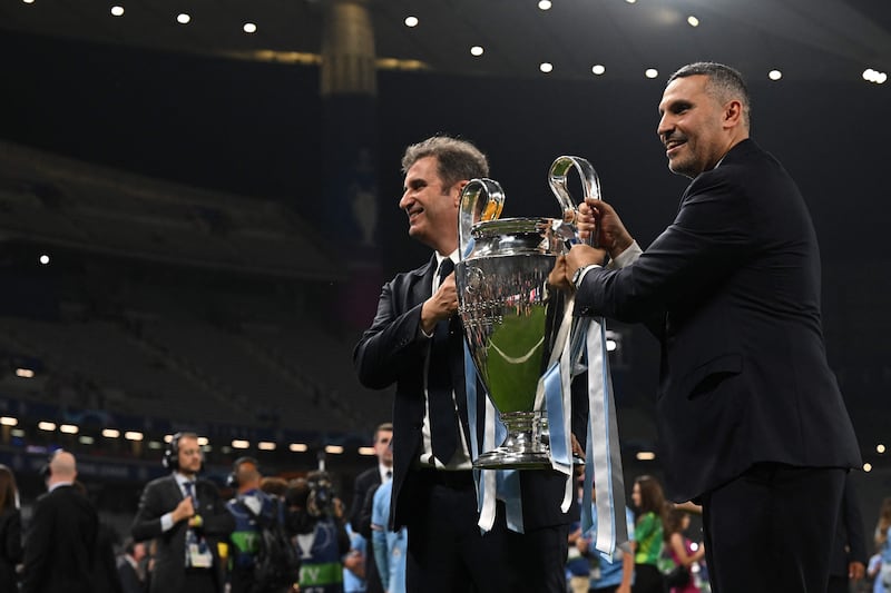 Manchester City's Emirati chairman Khaldoon al-Mubarak poses with the European Cup trophy as they celebrate winning the UEFA Champions League final. AFP