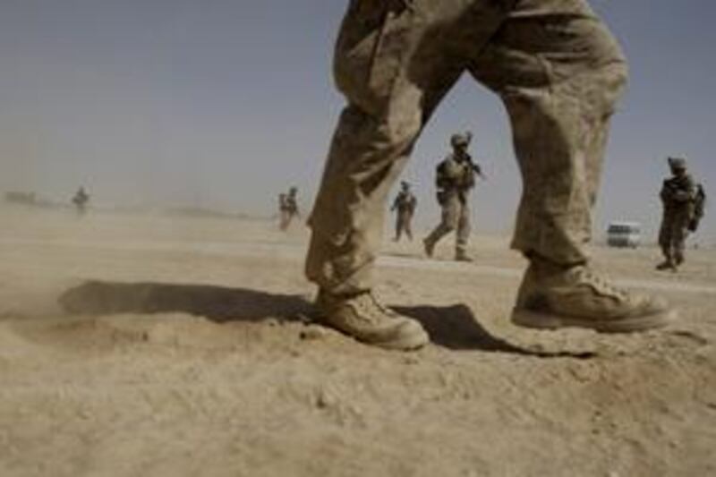 US Marines from the 2nd Marine Expeditionary Battalion walk through the sand inside Camp Leatherneck in Afghanistan's Helmand province Monday June 8, 2009.