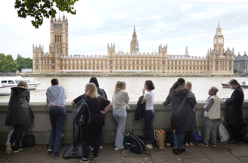 People in the queue on the South Bank opposite the Houses of Parliament. AP