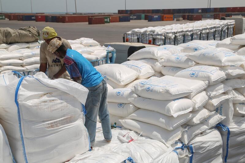 Yemenis receive sacks of food aid packages from the World Food Programme (WFP) in the Yemeni port city of Hodeida on June 25, 2019. - The escalation of attacks by Iran-aligned Huthi rebels on Saudi cities threatens a hard-won UN-sponsored ceasefire deal for the Red Sea port city of Hodeida, war-ravaged Yemen's main conduit for humanitarian aid. (Photo by - / AFP)