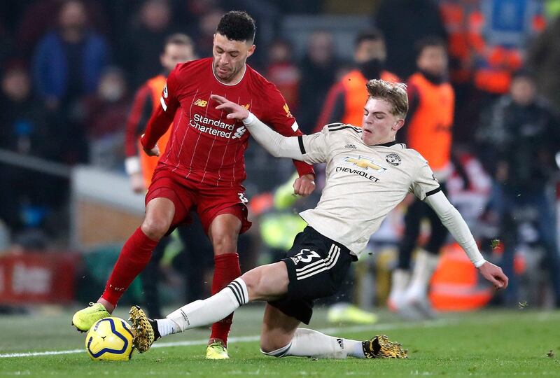 Liverpool's Alex Oxlade-Chamberlain is tackled by Manchester United's Brandon Williams. PA