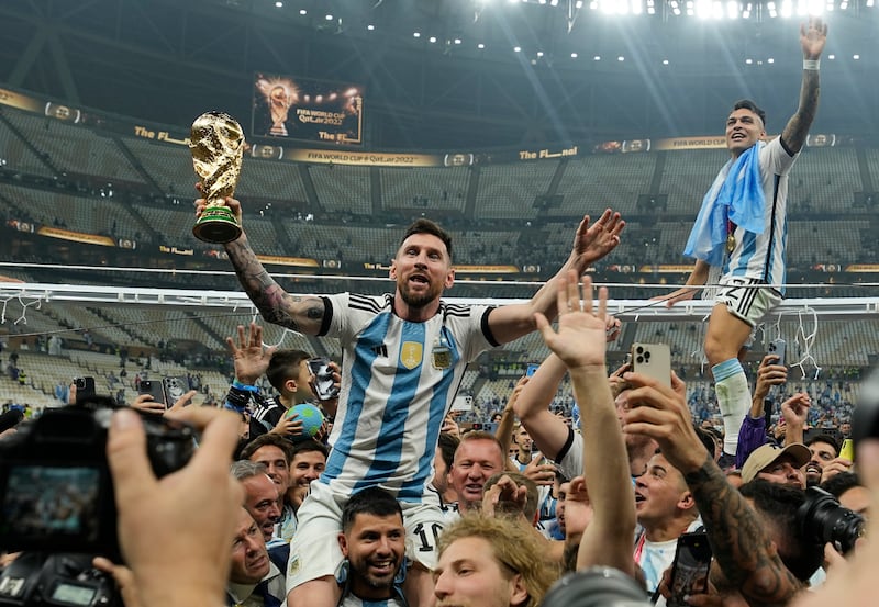Argentina's Lionel Messi celebrates with the trophy after beating France in the World Cup final at Lusail Stadium in Qatar on Sunday, December 18, 2022. Argentina won 4-2 in a penalty shoot-out after the match ended 3-3 after extra-time. AP